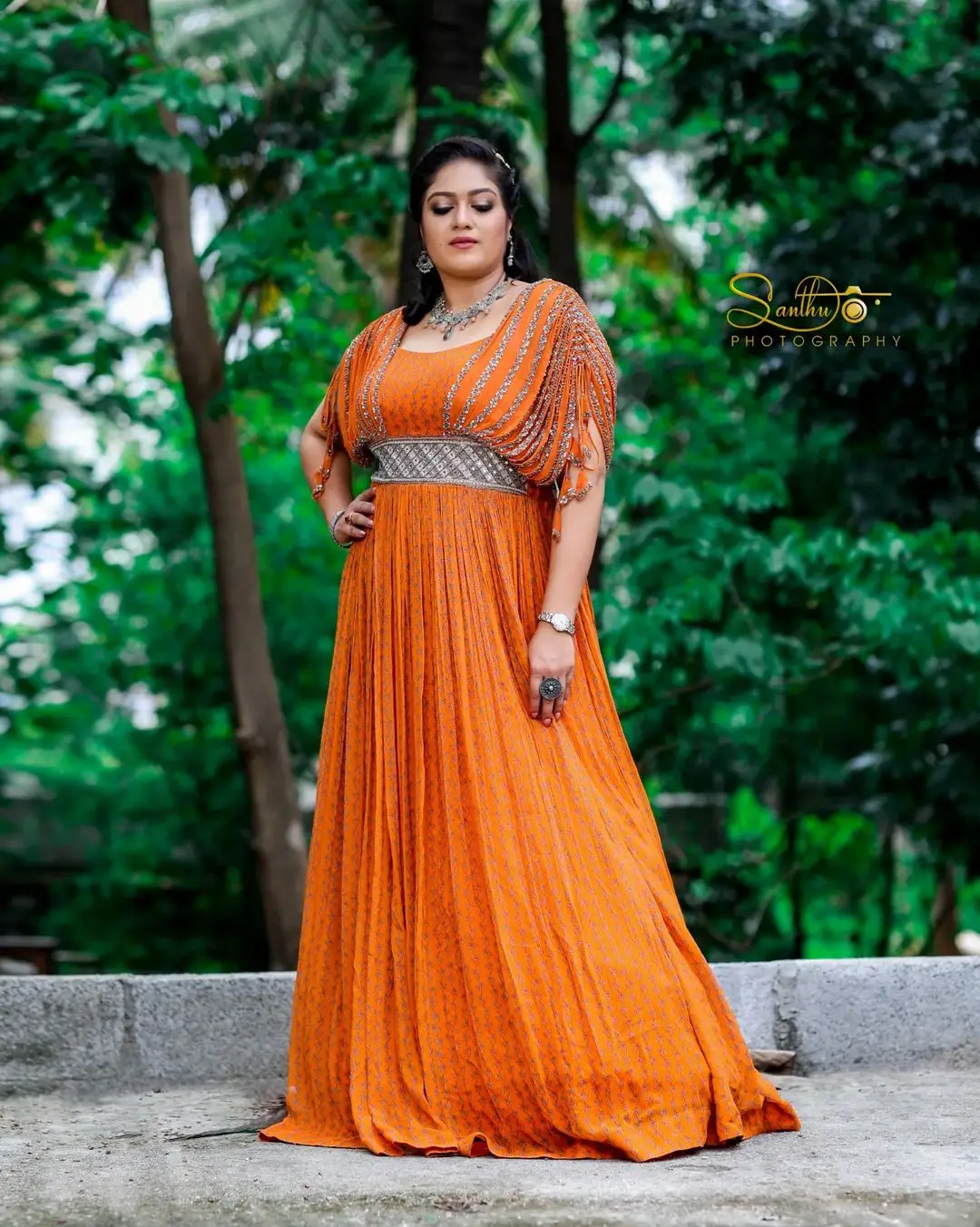 Meghana Raj Wearing Beautiful Earring Jewellery Orange Gown